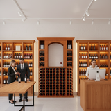 Wine cellar with wooden shelves and a reception desk.