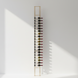 Wine rack with bottles against a white wall