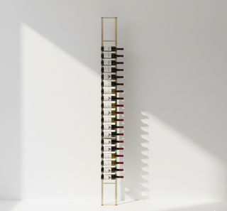 Wine rack with bottles against a white wall