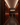Tall wine racks filled with bottles in a dimly lit wine cellar.