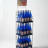 Metal display rack with blue bottles on a white background