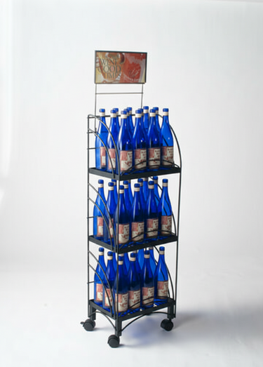 Metal display rack with blue bottles on a white background