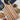 Wooden serving board with striped pattern on a white surface with snacks.