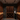 Man in a wine cellar examining bottles with wooden shelves and lighting fixtures.