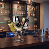 Wine bottles in a metal holder on a bar counter with shelves in the background
