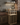 Wooden wine rack with bottles and glasses in a kitchen setting.