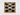 Wooden wall art with honeycomb design and black balls on a white background