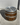 Wooden barrel with metal bands and cap on a concrete surface