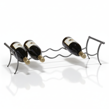 Wine rack holding three bottles on a white background