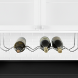 Wine rack holding three bottles of wine under a kitchen cabinet.