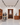 Modern wine cellar with wooden racks and people interacting.