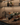 Wine bottles on a rack with glasses on a bar counter