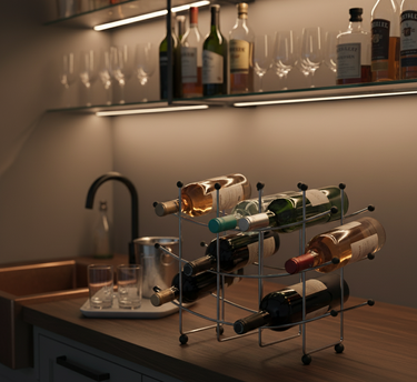 Wine bottles on a rack with glasses on a bar counter