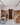Wine cellar with wooden shelves and people interacting, modern interior design.