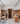 Wine cellar with wooden shelves and people interacting, modern interior design.