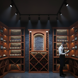Man in a wine cellar examining bottles