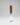Tall wooden wine rack on a reflective gray platform with a light gray background