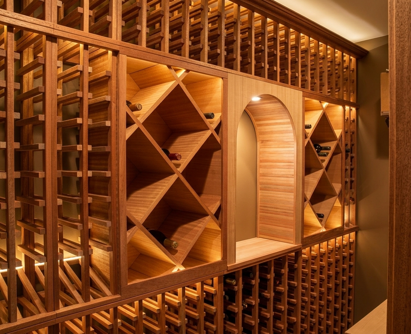 Wooden wine rack system with bottles in a well-lit room