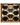 Wooden wall art with honeycomb design and black balls on a white background