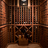 Wine cellar with wooden racks filled with wine bottles and a basket on the floor.