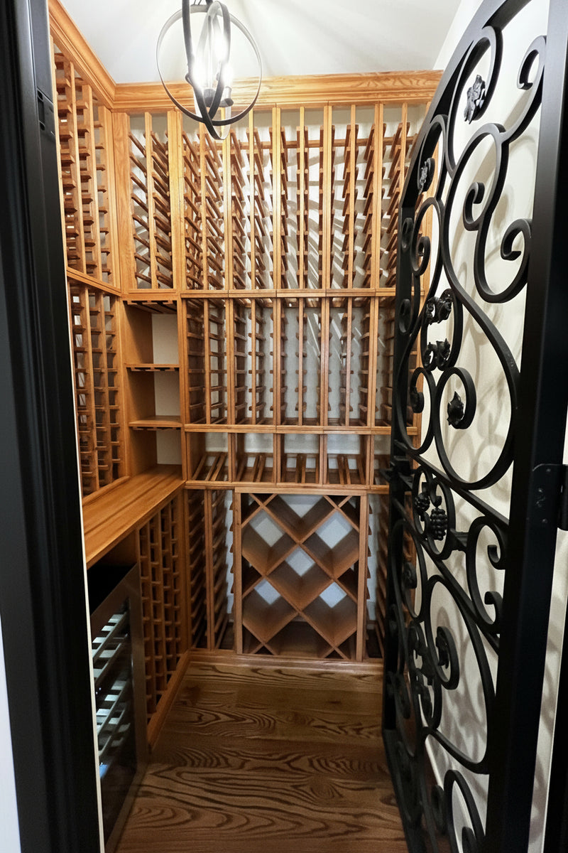 Wooden wine cellar with intricate metal door