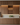 Modern kitchen with wooden cabinets and wine bottles.