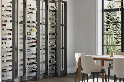 Modern wine cellar with open doors revealing bottles in a dining room setting.