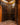 Wine cellar with wooden racks filled with wine bottles.