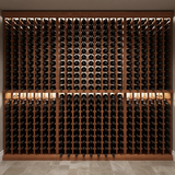 Wooden wine rack filled with wine bottles against a neutral wall.