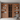Wooden bookshelf with wine rack and decorative items in a modern room.