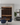 Modern interior with wine rack, dining table, and gray sofa.