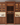 Wooden wine cellar with bottles and glasses in a kitchen setting
