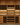 Wooden wine cellar with shelves filled with wine bottles