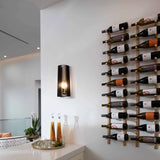 Wine bottles arranged on a wall-mounted rack in a modern interior setting.