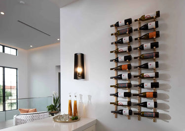 Wine bottles arranged on a wall-mounted rack in a modern interior setting.