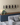 W Series Over the Couch Wine Rack Kit in Matte Black Storing 30 Bottles in a Living Room