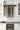 Wine bottles arranged vertically on a wall-mounted rack in a kitchen setting.