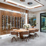 Modern dining area with wooden table and chairs, wine rack on the wall, and large glass door.