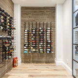 Wine bottles arranged on wooden racks in a modern interior setting.