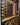 Wine rack with bottles on a wooden shelf in a modern interior setting.