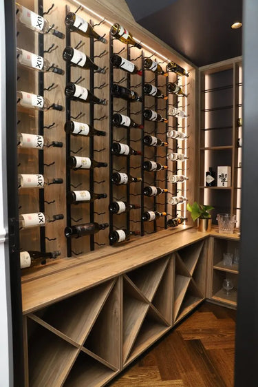 Wine rack with bottles on a wooden shelf in a modern interior setting.