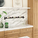 Modern kitchen with wooden cabinets, marble backsplash, and a loaf of bread on a white surface.