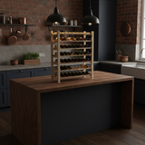 Wooden wine rack on a kitchen island with bottles inside, against a brick wall.