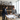 Two professionals discussing plans in a wine cellar with shelves and a large window.