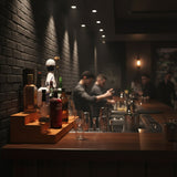 Bar setting with bottles and glasses on a counter, blurred background of people.