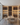 Modern wine cellar with illuminated shelves and a dining table.