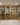 Wooden wine cellar with shelves filled with wine bottles.