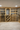 Wooden wine cellar with shelves filled with wine bottles.