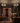 Luxury living room with wine rack, chandeliers, and people in formal attire.