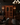 Luxury lounge with dark walls, leather furniture, and a wine rack.